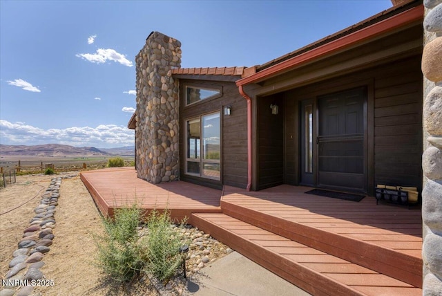 5455 Wild Horse Rd, Reno, NV 89510 - view of exterior entry with a deck with mountain view and a chimney