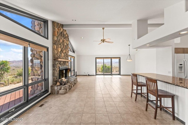 5455 Wild Horse Rd, Reno, NV 89510 - living area with ceiling fan, high vaulted ceiling, a fireplace, and light tile patterned flooring