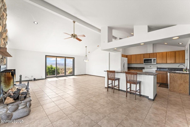 5455 Wild Horse Rd, Reno, NV 89510 - kitchen with white appliances, brown cabinetry, open floor plan, a ceiling fan, and beamed ceiling