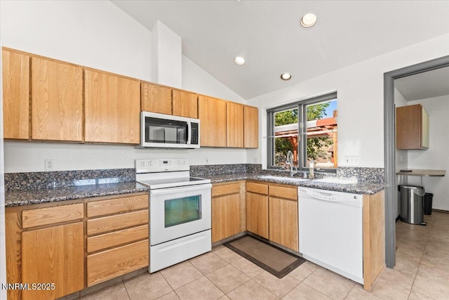 5455 Wild Horse Rd, Reno, NV 89510 - kitchen with white appliances, vaulted ceiling, light tile patterned flooring, recessed lighting, and dark stone counters