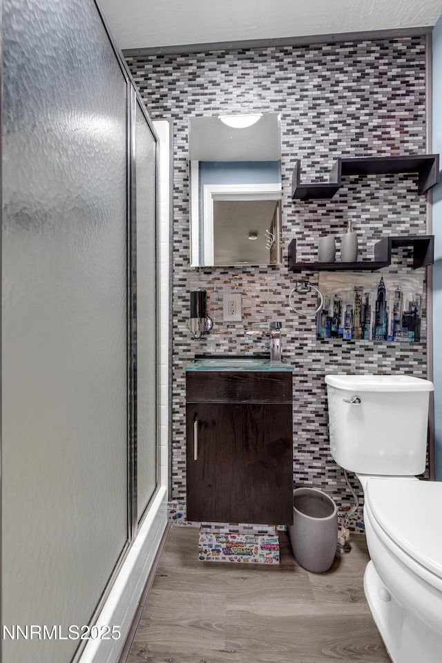 13250 Rolling Sage Pl, Reno, NV 89506 - full bathroom featuring vanity, a stall shower, wood finished floors, and backsplash