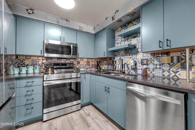 13250 Rolling Sage Pl, Reno, NV 89506 - kitchen featuring appliances with stainless steel finishes, blue cabinets, dark countertops, and open shelves