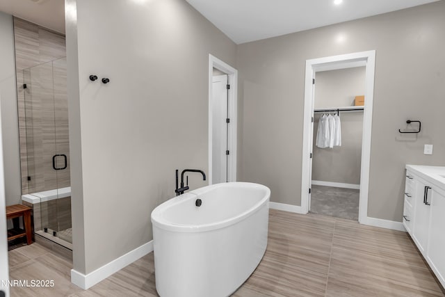 66 Caballada St, Reno, NV 89511 - bathroom with vanity, a spacious closet, a shower stall, and a soaking tub