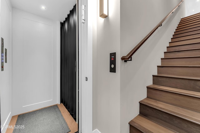 66 Caballada St, Reno, NV 89511 - staircase featuring wood finished floors, elevator, and recessed lighting