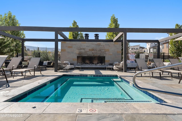 66 Caballada St, Reno, NV 89511 - view of swimming pool featuring a patio, a pool, and an outdoor stone fireplace