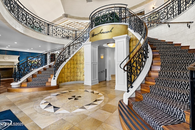 66 Caballada St, Reno, NV 89511 - entrance foyer with a towering ceiling, ornate columns, inlaid floor details, stairway, and recessed lighting