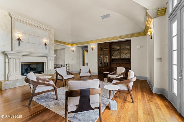 66 Caballada St, Reno, NV 89511 - living room featuring vaulted ceiling, wood finished floors, a premium fireplace, and ornamental molding