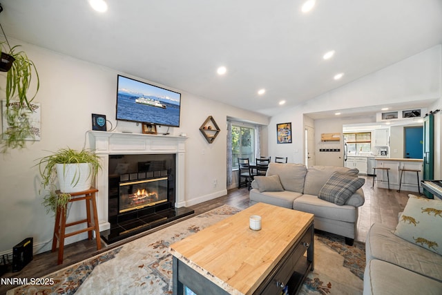 2787 Randolph Dr, Reno, NV 89502 - living room featuring a fireplace, recessed lighting, wood finished floors, and vaulted ceiling