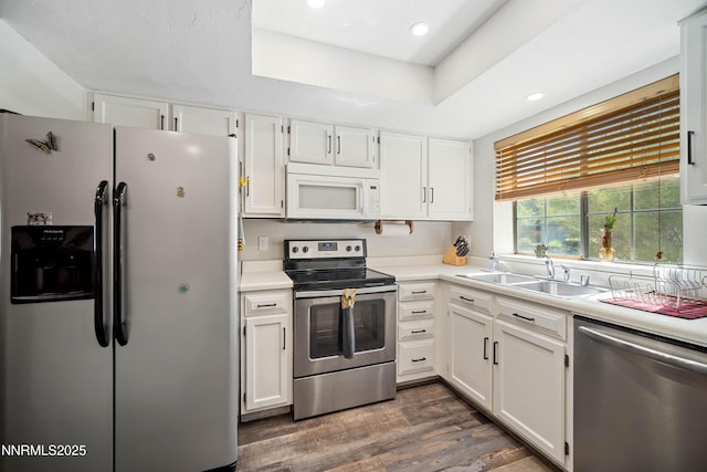 2787 Randolph Dr, Reno, NV 89502 - kitchen featuring appliances with stainless steel finishes, white cabinetry, dark wood-style floors, light countertops, and recessed lighting