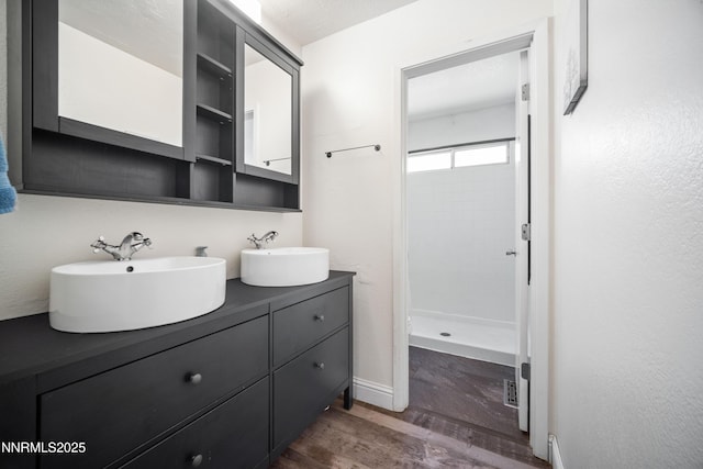 2787 Randolph Dr, Reno, NV 89502 - full bathroom with double vanity, a shower stall, and wood finished floors
