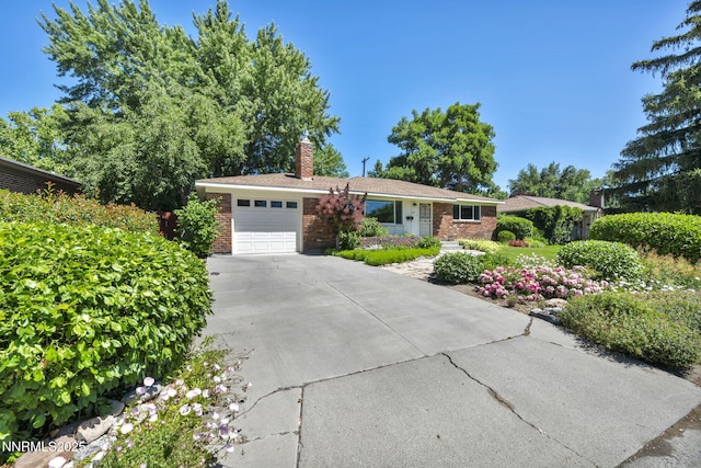 825 W 11th St, Reno, NV 89503 - ranch-style house featuring a garage, brick siding, a chimney, and concrete driveway