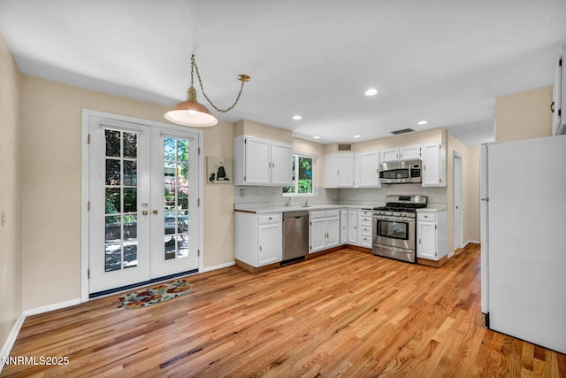 825 W 11th St, Reno, NV 89503 - kitchen with stainless steel appliances, light wood-style flooring, light countertops, white cabinetry, and recessed lighting