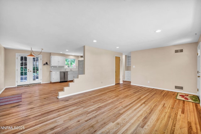 825 W 11th St, Reno, NV 89503 - unfurnished living room featuring light wood-style flooring, recessed lighting, and french doors