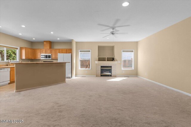 9732 Autumn Leaf Way, Reno, NV 89506 - unfurnished living room with recessed lighting, a fireplace, light colored carpet, and a ceiling fan