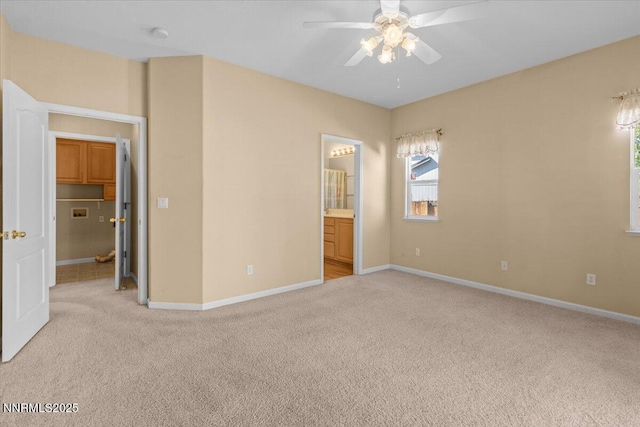 9732 Autumn Leaf Way, Reno, NV 89506 - unfurnished bedroom featuring light carpet, connected bathroom, and a ceiling fan