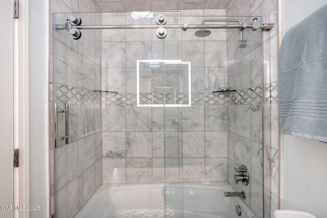 100 N Arlington Ave Unit 17G, Reno, NV 89501 - bathroom featuring bath / shower combo with glass door and toilet