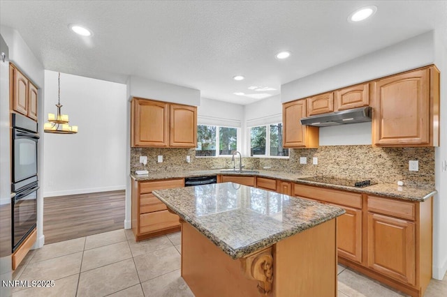 4413 Desert Hills Ct, Sparks, NV 89436 - kitchen with black appliances, under cabinet range hood, light stone counters, decorative backsplash, and a kitchen island
