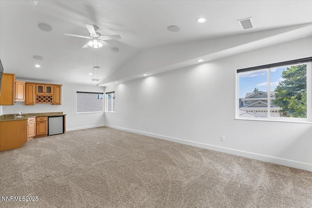 4413 Desert Hills Ct, Sparks, NV 89436 - unfurnished living room featuring lofted ceiling, ceiling fan, light colored carpet, wet bar, and recessed lighting