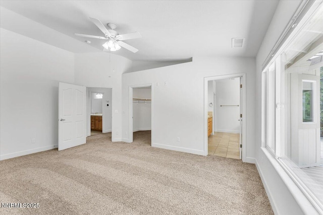 4413 Desert Hills Ct, Sparks, NV 89436 - unfurnished bedroom with light carpet, vaulted ceiling, connected bathroom, a spacious closet, and a ceiling fan