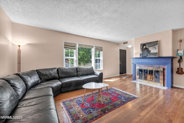 1725 Westfield Ave, Reno, NV 89509 - living area with wood finished floors, a brick fireplace, and a textured ceiling