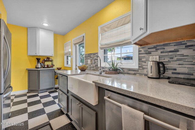 1725 Westfield Ave, Reno, NV 89509 - kitchen with appliances with stainless steel finishes, light floors, backsplash, light stone counters, and recessed lighting