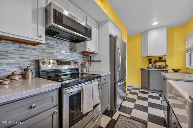 1725 Westfield Ave, Reno, NV 89509 - kitchen featuring appliances with stainless steel finishes, dark flooring, gray cabinets, and white cabinetry