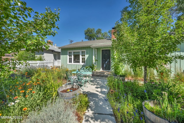 1725 Westfield Ave, Reno, NV 89509 - view of front facade with board and batten siding, a patio area, and a chimney