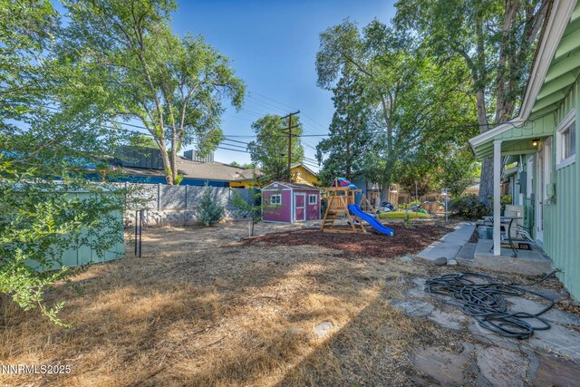 1725 Westfield Ave, Reno, NV 89509 - fenced backyard with a storage unit and a playground