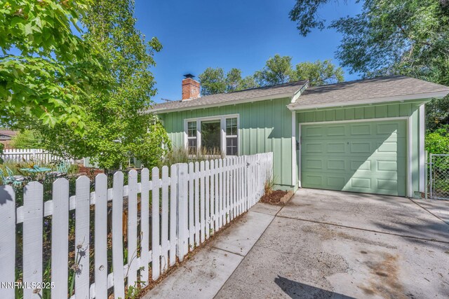 1725 Westfield Ave, Reno, NV 89509 - view of front of home featuring board and batten siding, a chimney, concrete driveway, a garage, and a shingled roof