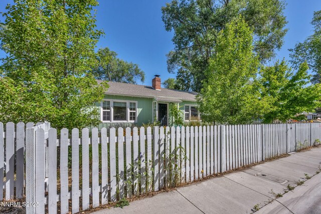 1725 Westfield Ave, Reno, NV 89509 - view of front facade featuring a chimney, a fenced front yard, and a shingled roof