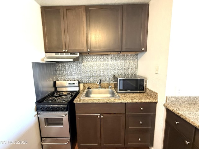 2450 Lymbery St Unit 219, Reno, NV 89509 - kitchen featuring appliances with stainless steel finishes, under cabinet range hood, tasteful backsplash, and dark brown cabinetry