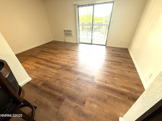 2450 Lymbery St Unit 219, Reno, NV 89509 - unfurnished living room featuring wood finished floors and an AC wall unit