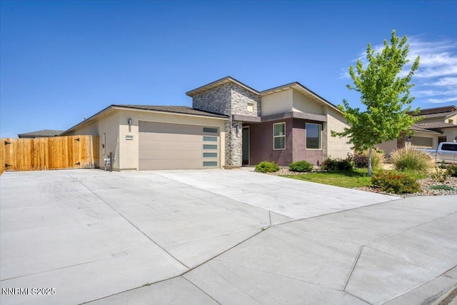 2251 Slater Mill Dr, Sparks, NV 89441 - contemporary house featuring an attached garage, stucco siding, concrete driveway, and stone siding