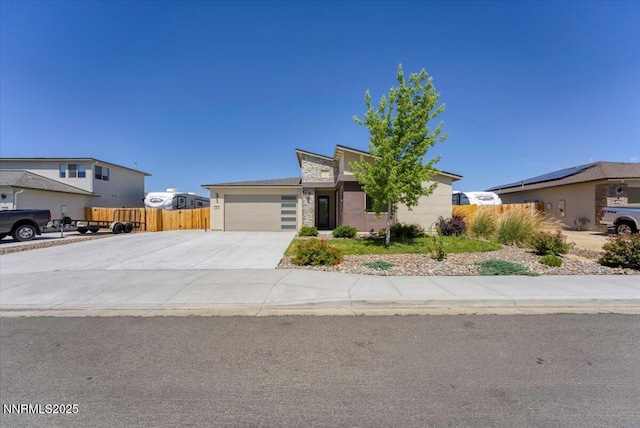 2251 Slater Mill Dr, Sparks, NV 89441 - view of front of property featuring driveway, an attached garage, stone siding, and stucco siding