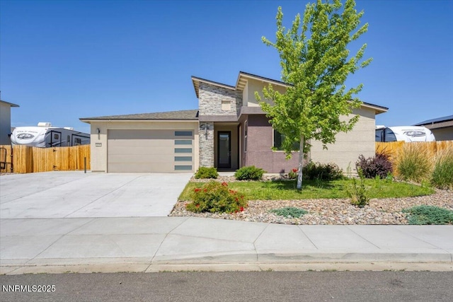 2251 Slater Mill Dr, Sparks, NV 89441 - view of front of property featuring a garage, stucco siding, driveway, and stone siding