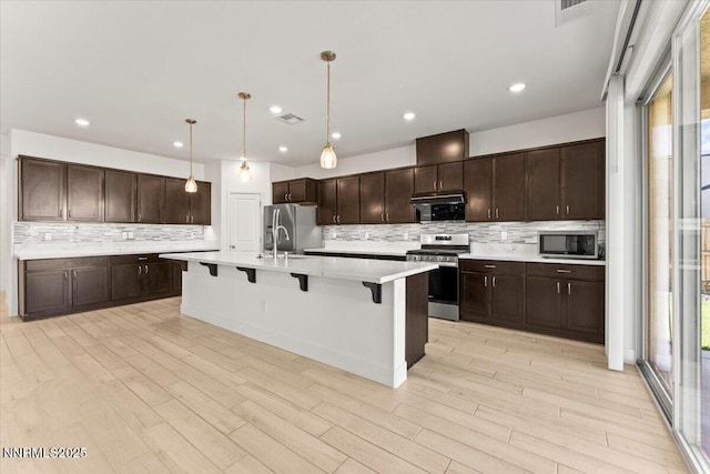 2251 Slater Mill Dr, Sparks, NV 89441 - kitchen with stainless steel appliances, plenty of natural light, a breakfast bar, decorative backsplash, and recessed lighting