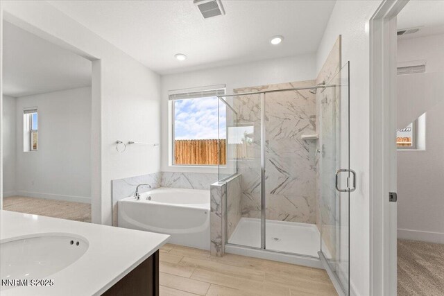 2251 Slater Mill Dr, Sparks, NV 89441 - full bath featuring vanity, a garden tub, a marble finish shower, and wood finished floors
