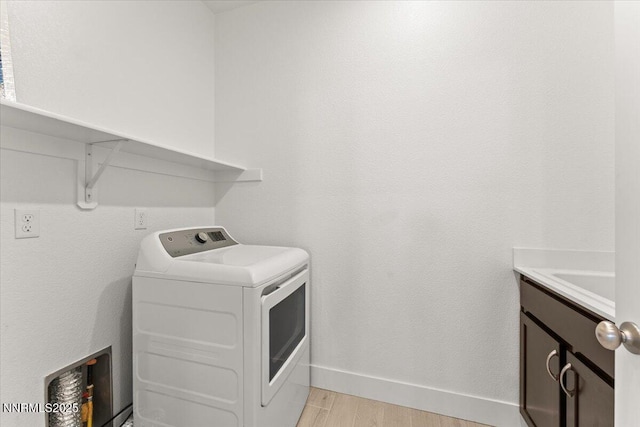 2251 Slater Mill Dr, Sparks, NV 89441 - laundry room featuring cabinet space and light wood-style floors