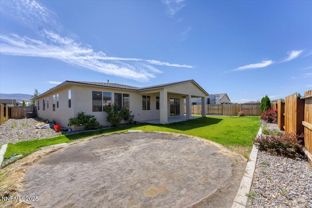 2251 Slater Mill Dr, Sparks, NV 89441 - rear view of property featuring stucco siding, a fenced backyard, and a patio