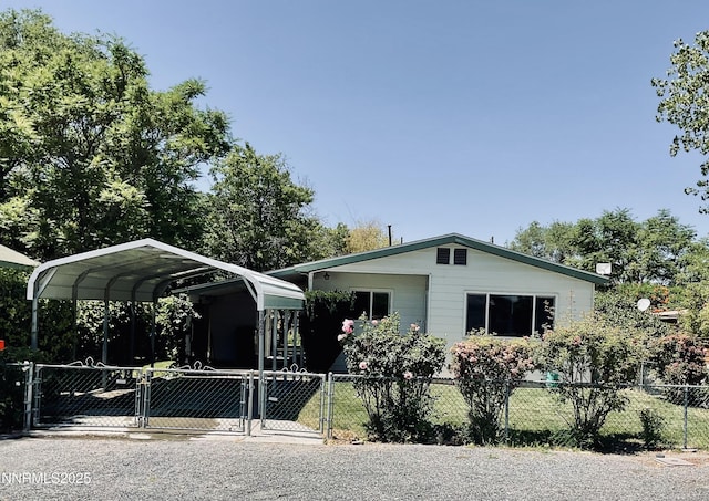 1685 Elmhurst Ave, Lovelock, NV 89419 - view of side of home featuring a carport, a fenced front yard, and a gate