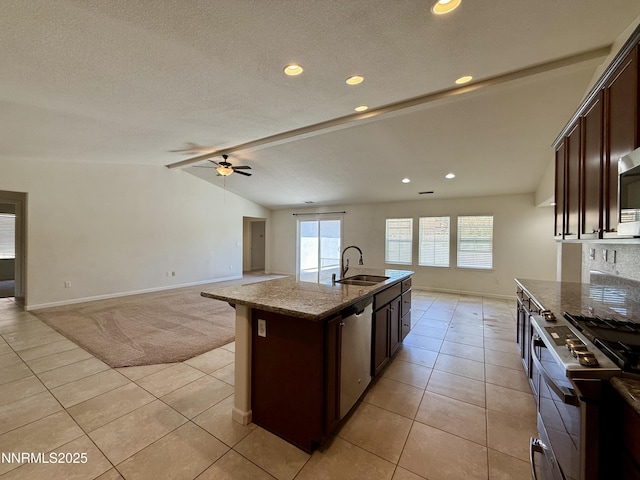 1122 Ferretto Pkwy, Dayton, NV 89403 - kitchen featuring appliances with stainless steel finishes, light tile patterned floors, dark brown cabinetry, ceiling fan, and light stone counters