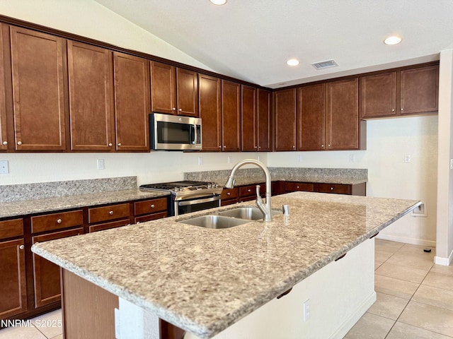 1122 Ferretto Pkwy, Dayton, NV 89403 - kitchen with stainless steel appliances, lofted ceiling, light tile patterned flooring, light stone counters, and recessed lighting