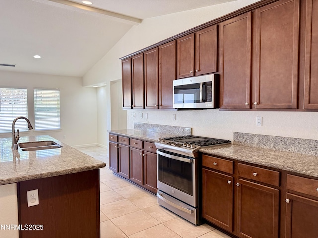 1122 Ferretto Pkwy, Dayton, NV 89403 - kitchen with stainless steel appliances, light tile patterned floors, light stone counters, and recessed lighting