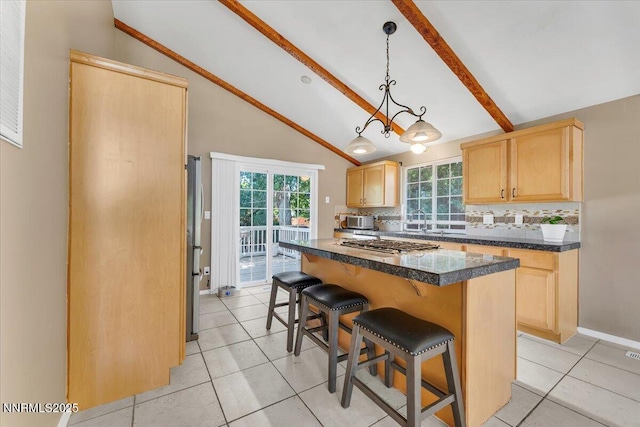 1782 Driftwood Dr, Sparks, NV 89431 - kitchen with light brown cabinets, backsplash, a kitchen breakfast bar, dark countertops, and appliances with stainless steel finishes