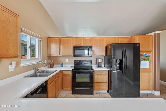 7358 Rubens Ct, Sun Valley, NV 89433 - kitchen featuring black appliances, light tile patterned flooring, vaulted ceiling, and light countertops