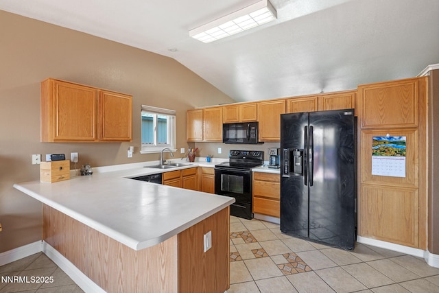 7358 Rubens Ct, Sun Valley, NV 89433 - kitchen featuring black appliances, light tile patterned floors, vaulted ceiling, a peninsula, and light countertops