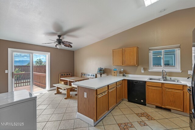 7358 Rubens Ct, Sun Valley, NV 89433 - kitchen with dishwasher, a peninsula, vaulted ceiling, ceiling fan, and light tile patterned flooring