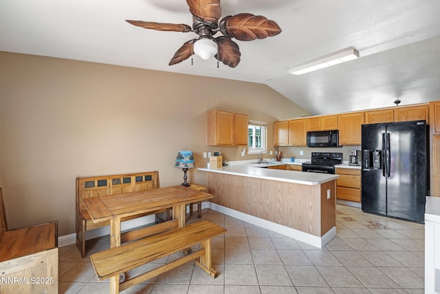 7358 Rubens Ct, Sun Valley, NV 89433 - kitchen featuring black appliances, vaulted ceiling, a peninsula, ceiling fan, and light countertops