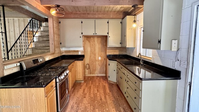 157 Cottonwood Dr, Stateline, NV 89449 - kitchen with stainless steel range with gas stovetop, a wooden ceiling with exposed beams, light wood-style flooring, decorative backsplash, and decorative light fixtures