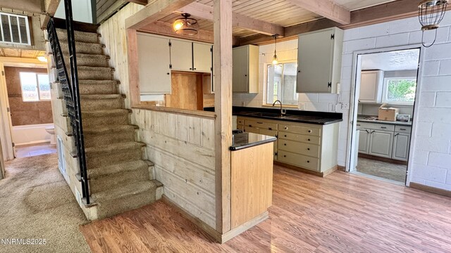 157 Cottonwood Dr, Stateline, NV 89449 - kitchen featuring light wood finished floors, dark countertops, a wooden ceiling with exposed beams, and pendant lighting